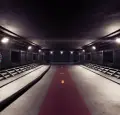 Magic Media Unity Game Development. A futuristic, dimly lit metallic corridor with a red walkway and yellow arrows.